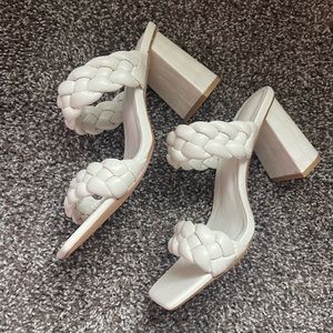 White heels with braiding.